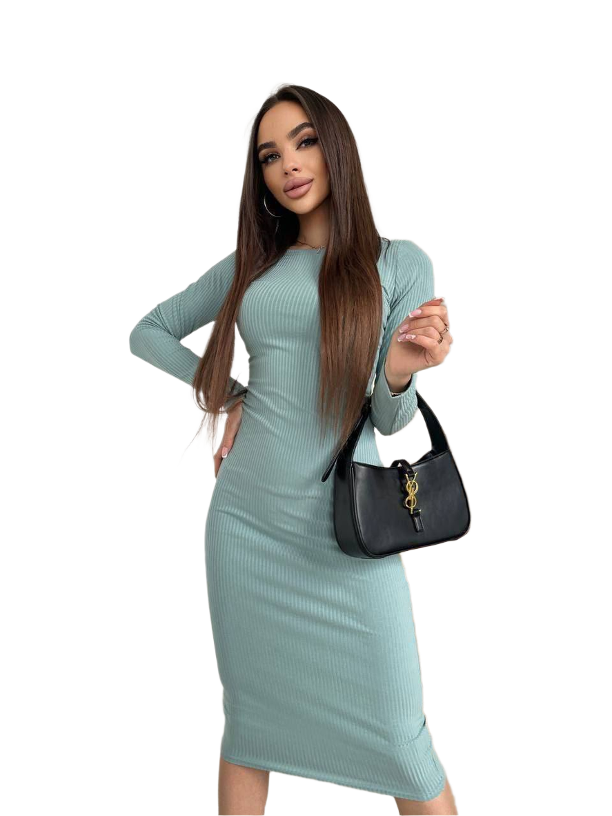 Woman wearing a light blue ribbed dress holding a black handbag on a white background