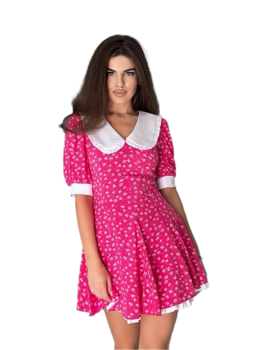 Woman wearing a pink dress with white collar and trim on a white background