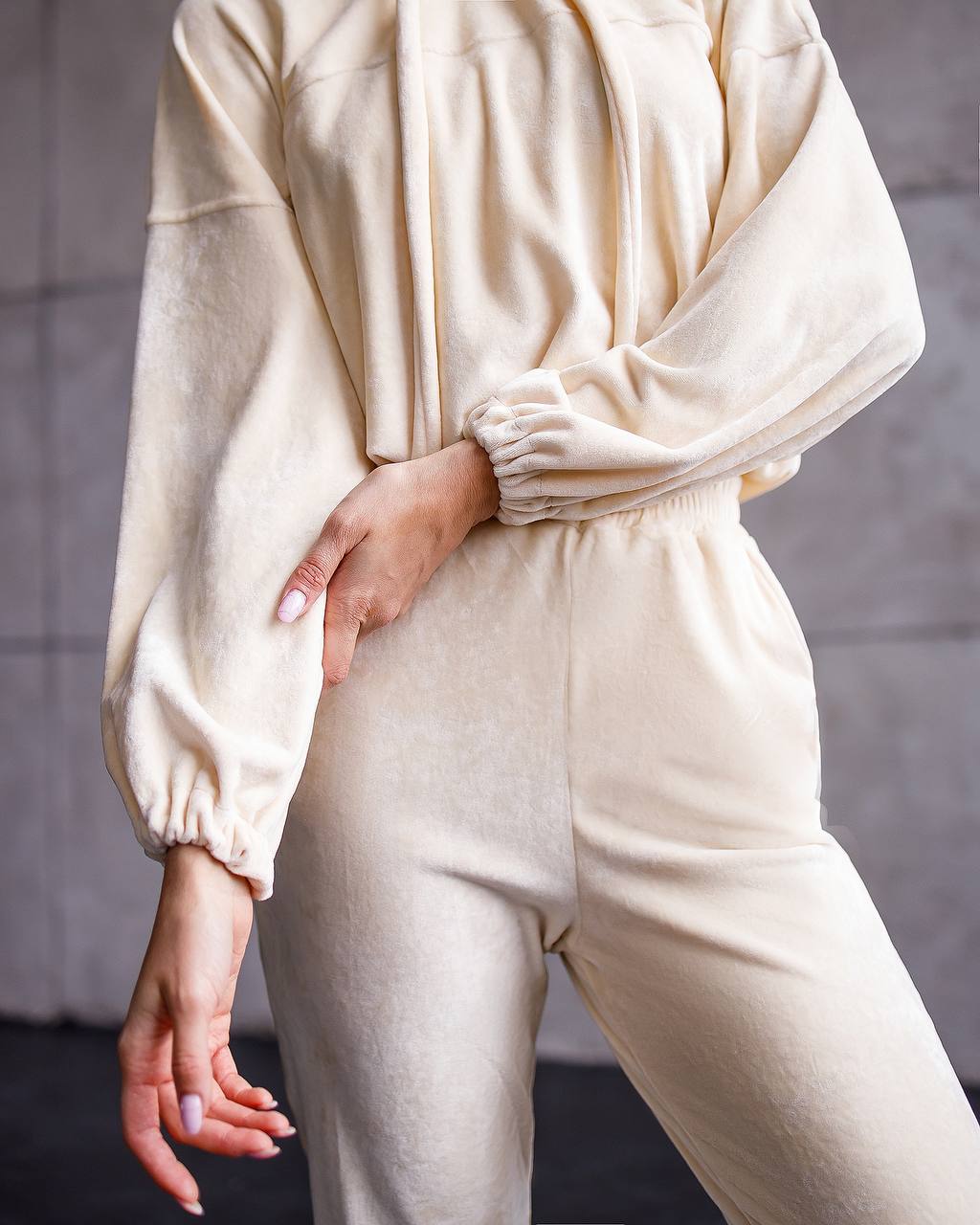 Person wearing a beige loungewear set against a neutral background