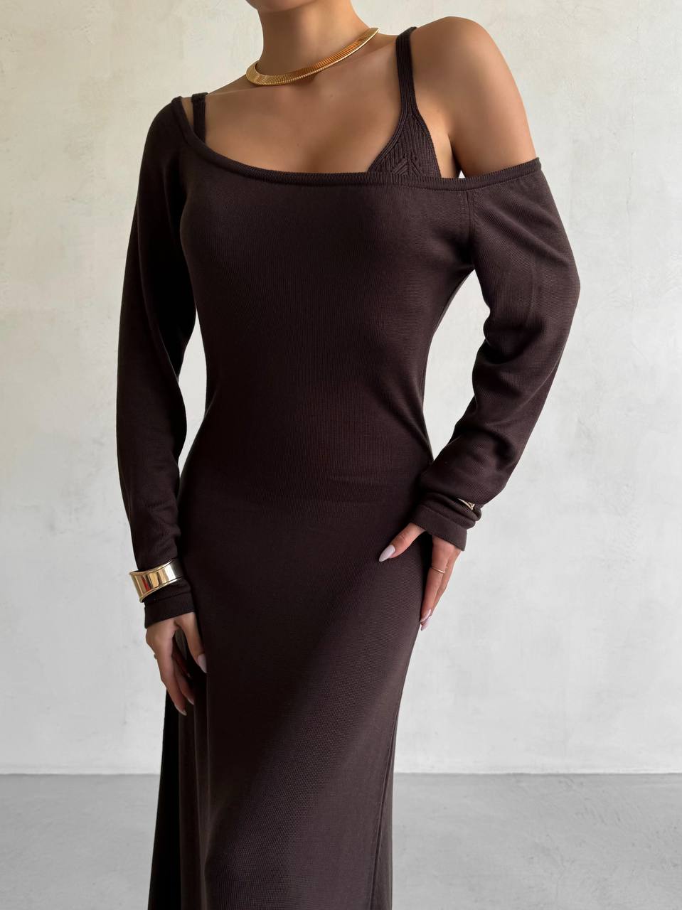 Brown long-sleeve dress worn by a person against a plain background
