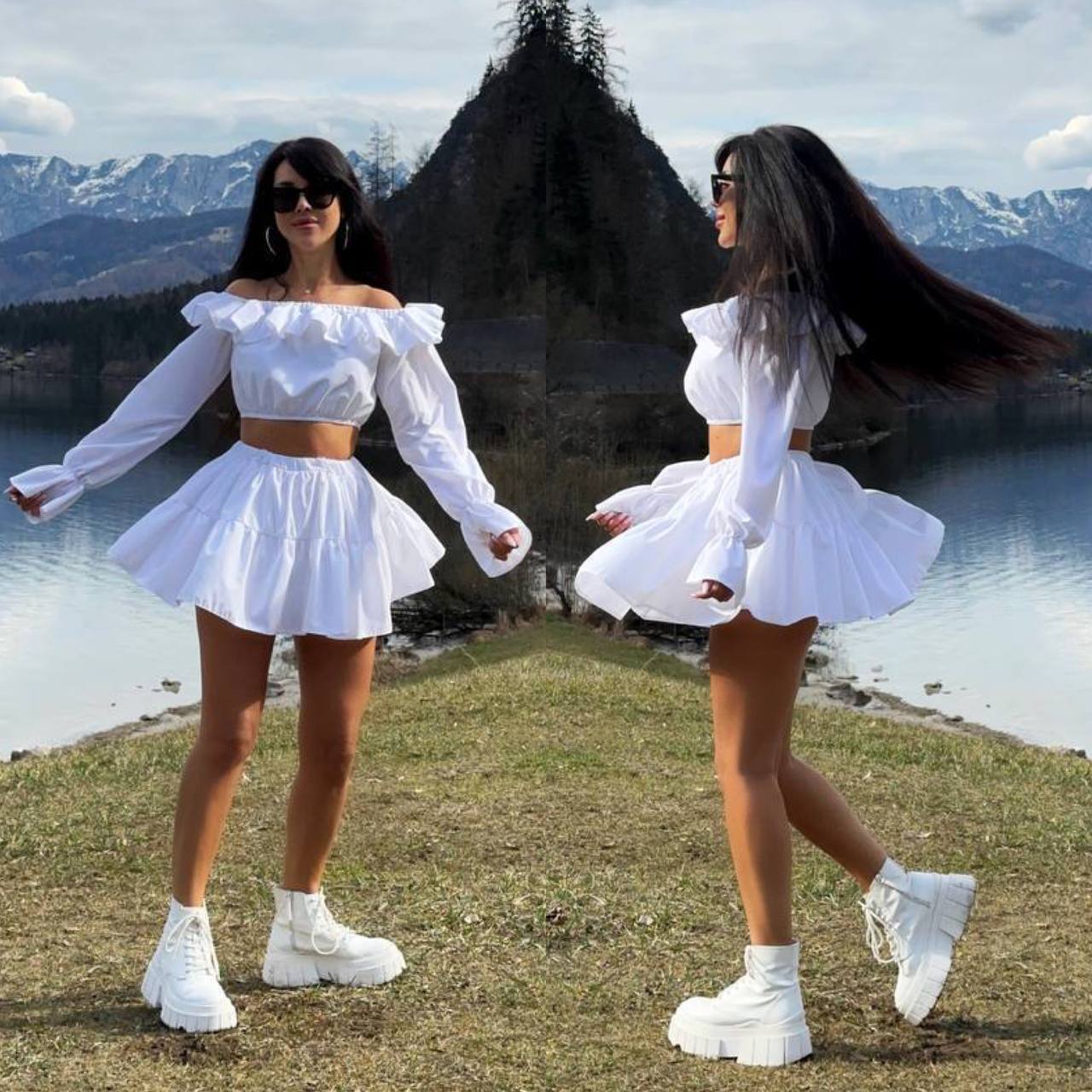 Woman in a white outfit with ruffled sleeves and skirt standing in front of a scenic lake and mountains.