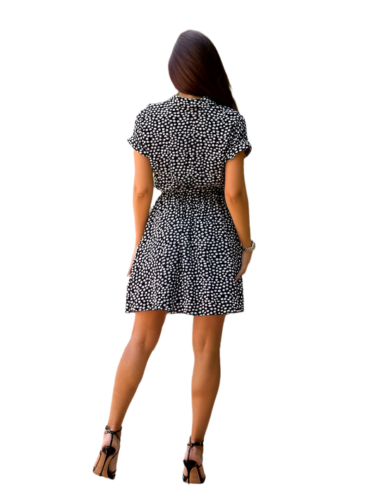 Woman wearing a black and white patterned dress on a white background