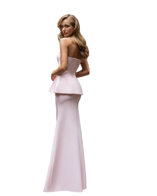 Woman wearing a strapless pink evening gown on a white background