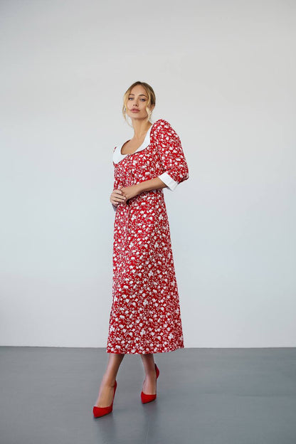 Woman wearing a red floral dress with white background
