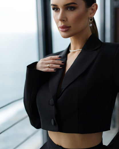 Woman wearing a black blazer with a blurred background