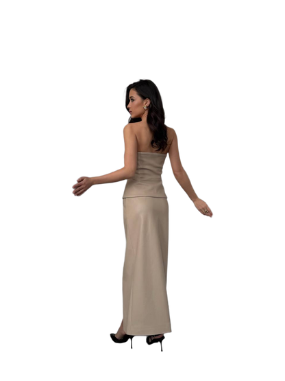 Woman wearing a beige strapless gown on a white background