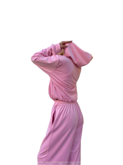 Person wearing a pink tracksuit on a white background