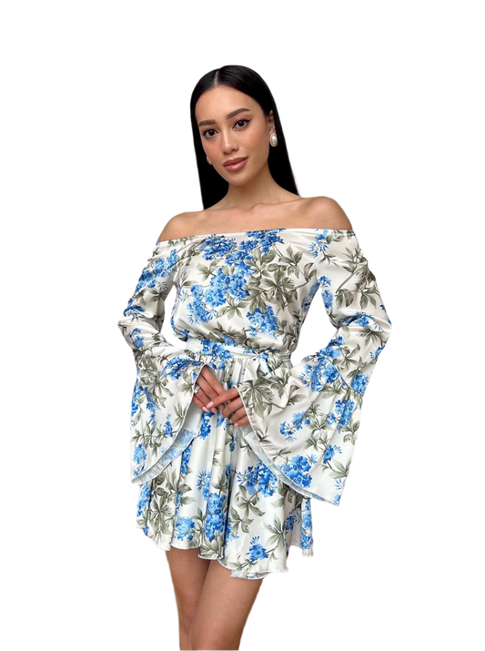 Woman wearing a floral off-shoulder dress on a white background
