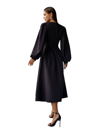Woman wearing a black dress with long sleeves on a white background