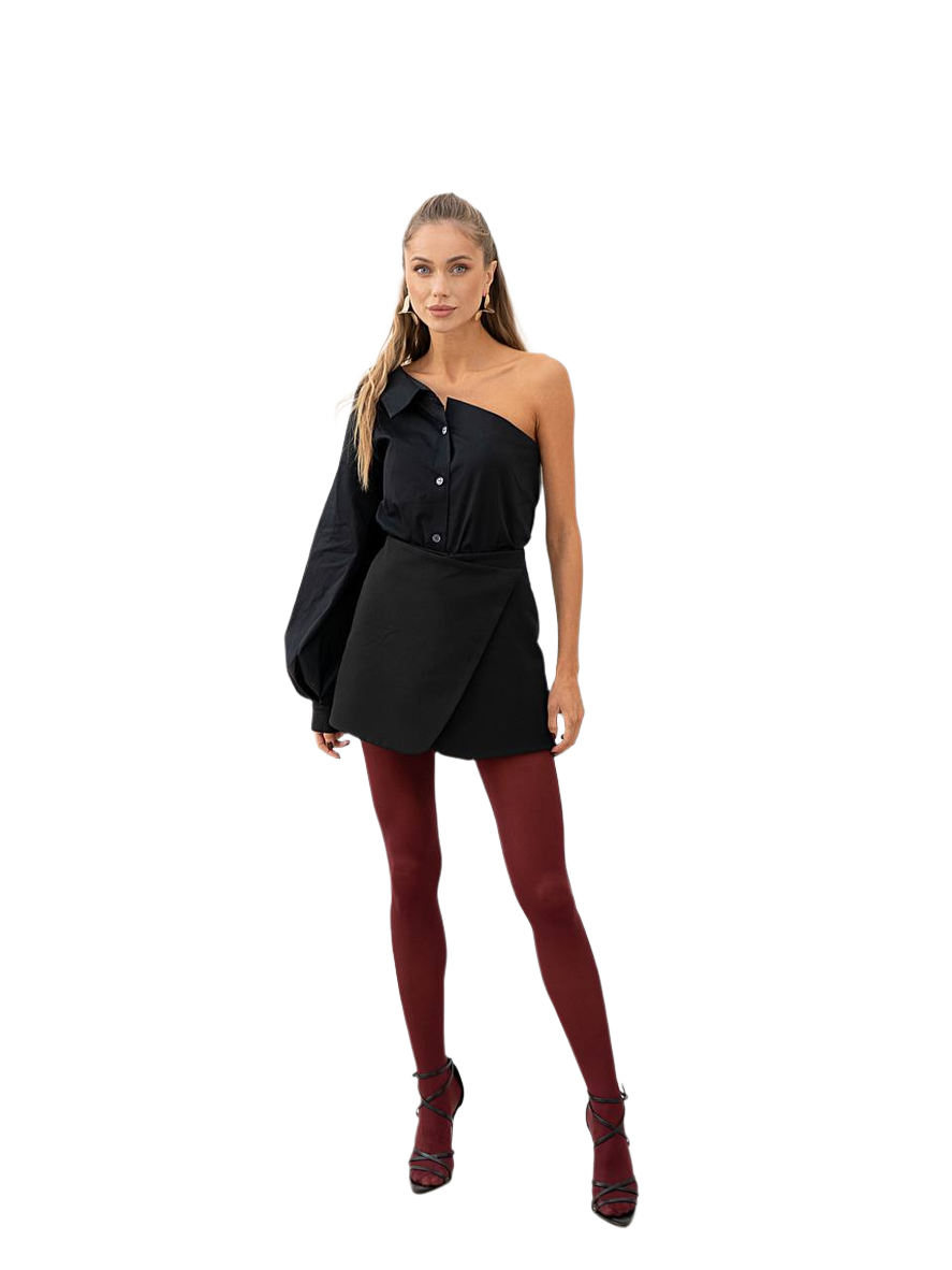 Woman wearing a black outfit with red tights on a white background