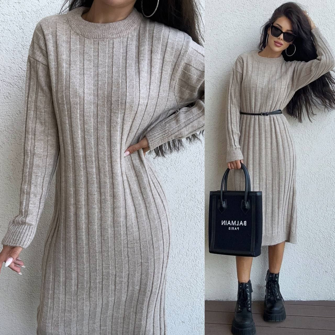 Beige ribbed dress worn by a model against a white background