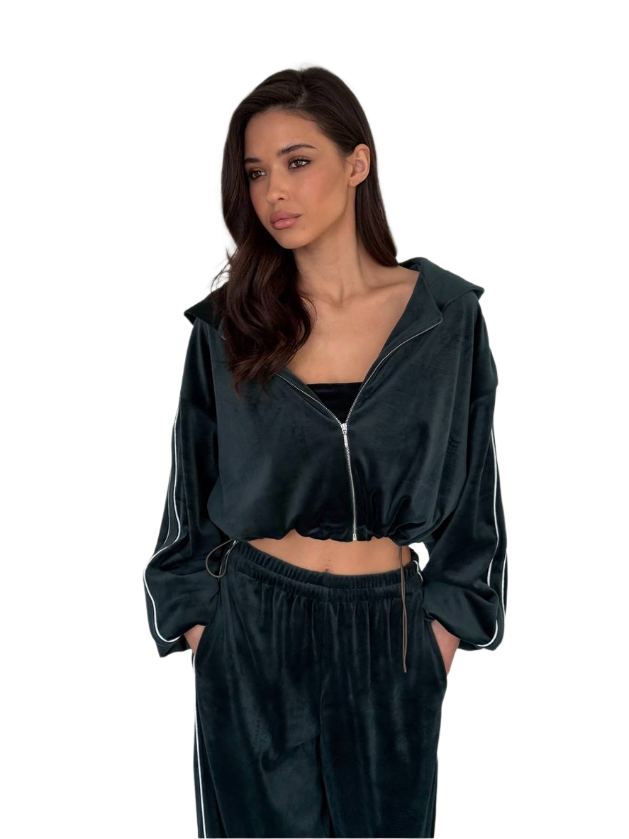 Woman wearing a dark green tracksuit with a hood on a white background