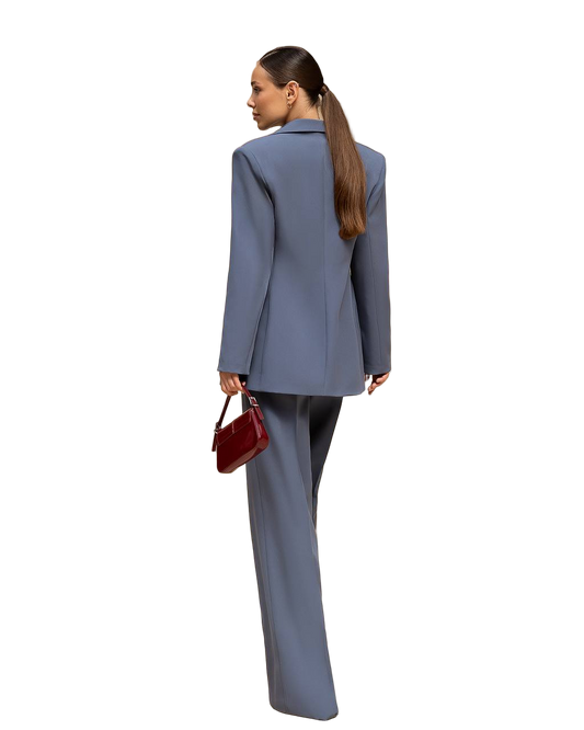 Woman wearing a gray suit with a red handbag on a white background