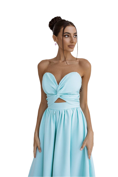 Woman wearing a light blue strapless dress with a cutout design on a white background