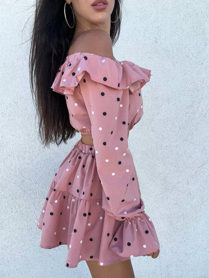 Woman wearing a pink polka dot dress against a light background