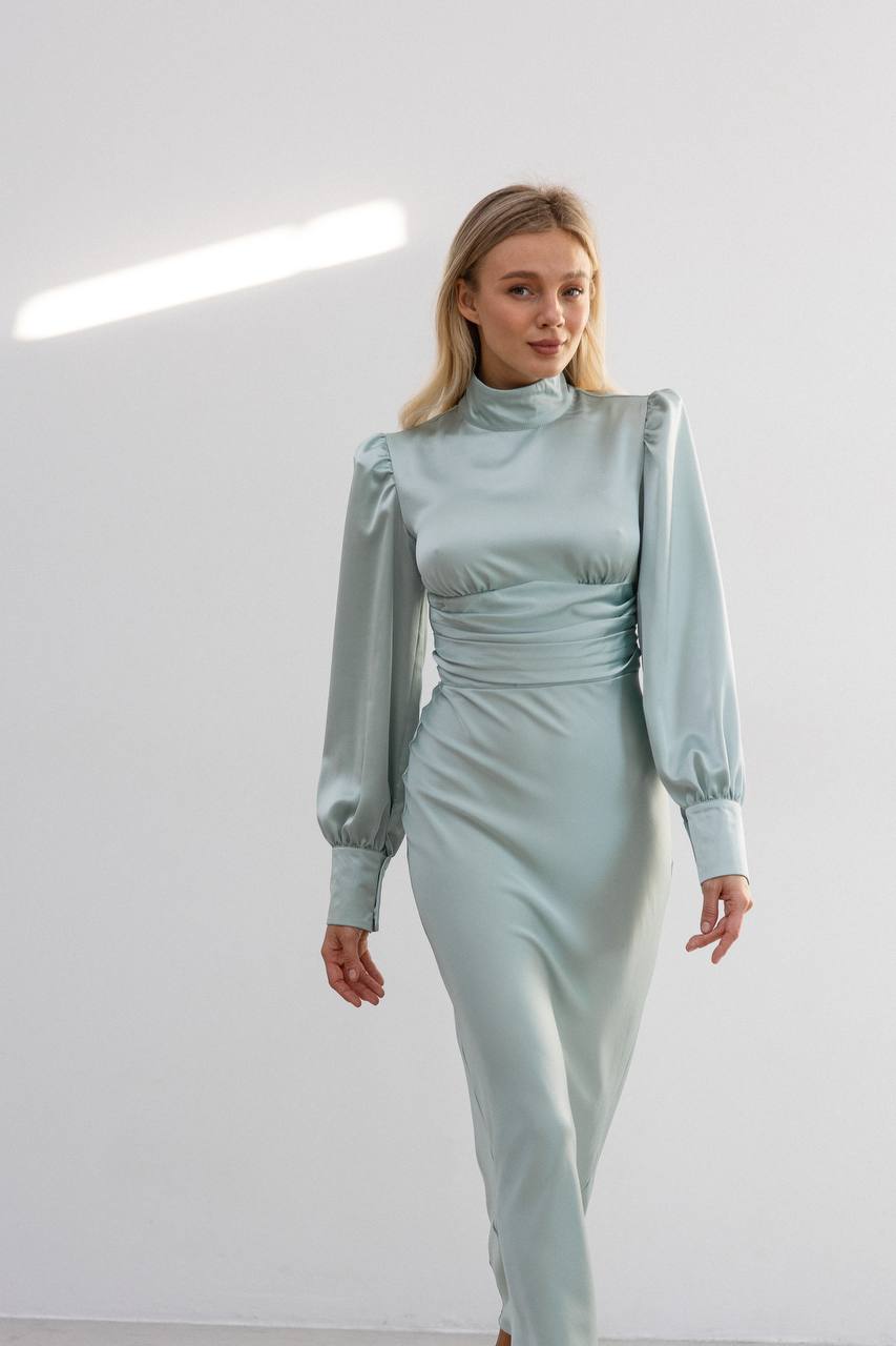 Woman wearing a light blue dress against a white background