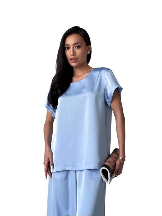 Woman wearing a light blue outfit on a white background