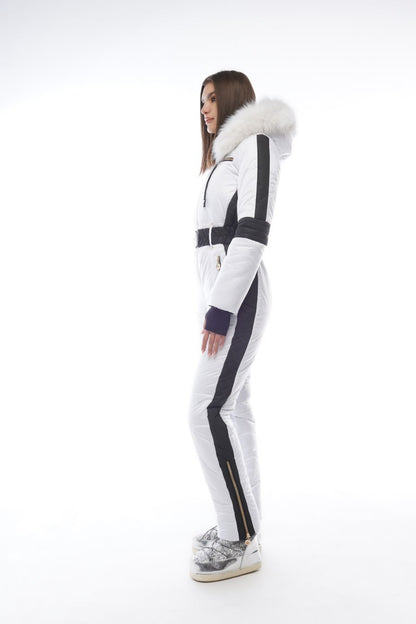Person wearing a white and black snowsuit with fur trim on a white background