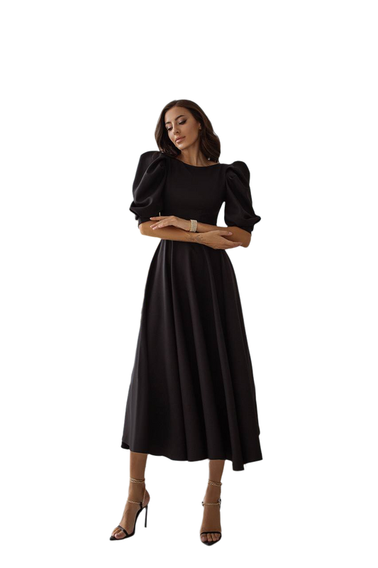 Woman wearing a black dress with puffed sleeves on a white background