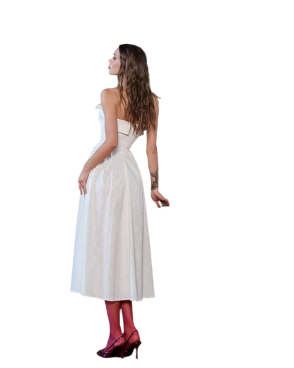 Woman wearing a white dress with red shoes on a white background