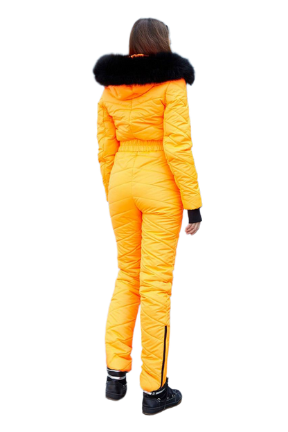 Person wearing a bright yellow snowsuit with black fur trim on a white background
