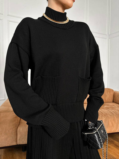 Person wearing a black sweater with a blurred background