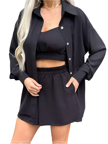 Person wearing a black outfit with a cardigan on a white background