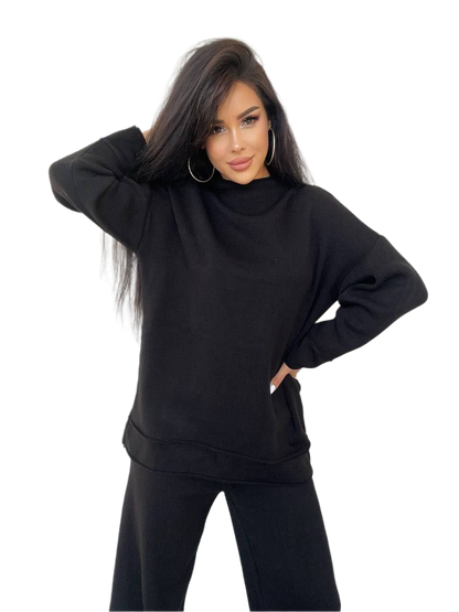 Woman wearing a black oversized hoodie on a white background