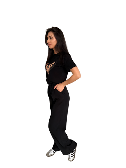 Woman wearing a black outfit with a logo on a white background