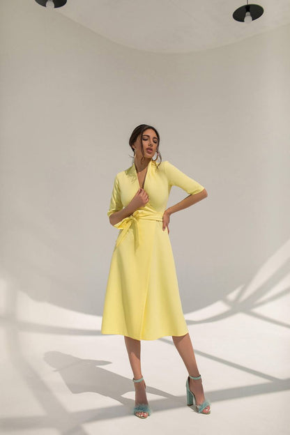 Woman wearing a yellow dress in a studio setting