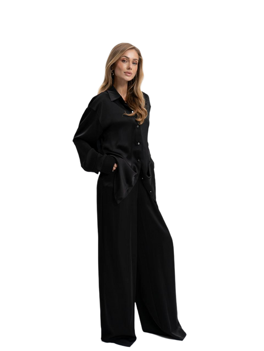 Woman wearing a black dress with a belt on a white background