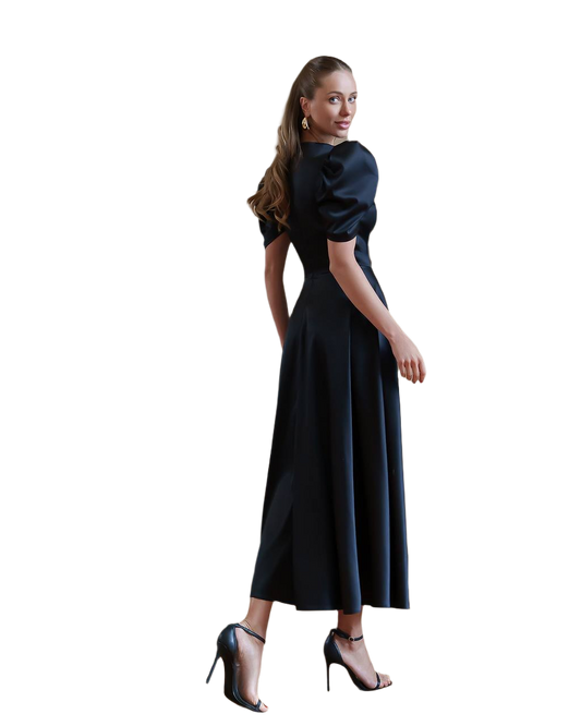 Woman wearing a black dress with puffed sleeves on a white background