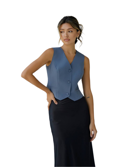 Woman wearing a blue vest over a black dress on a white background