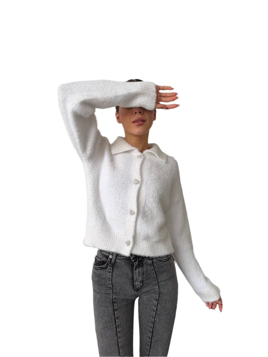 Person wearing a white cardigan and gray pants on a white background