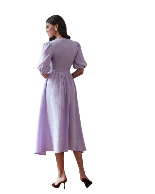 Woman wearing a light purple dress with puffed sleeves on a white background