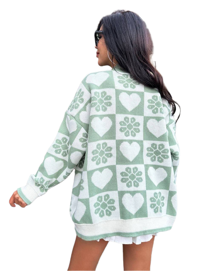 Woman wearing a green and white patterned cardigan on a white background