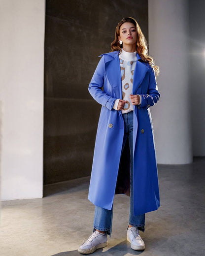 Woman wearing a blue coat in an indoor setting