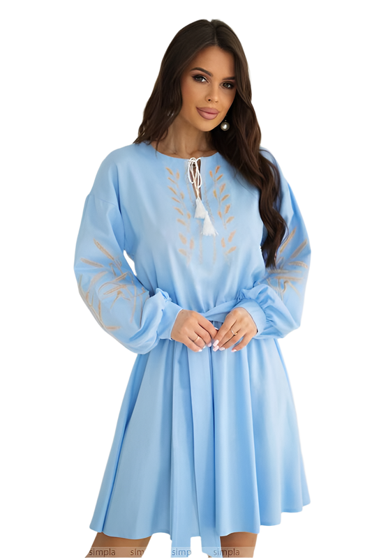 Woman wearing a light blue dress with lace details on a white background