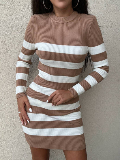 Brown and white striped dress worn by a person against a plain background