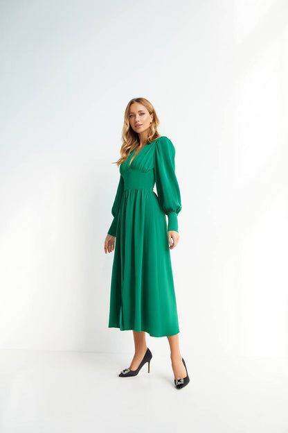 Woman wearing a green dress on a white background
