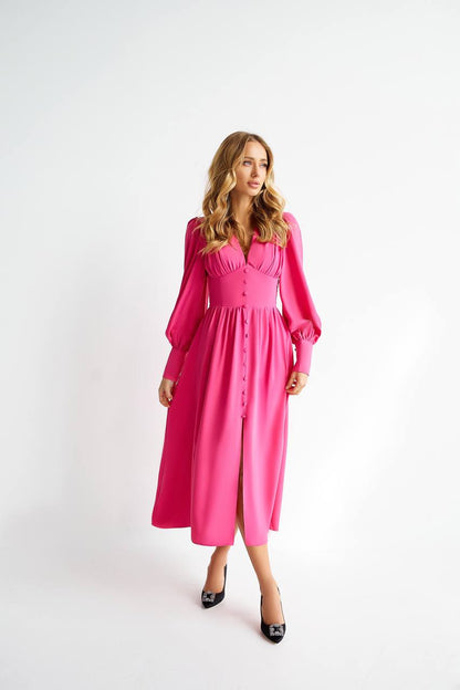 Woman wearing a pink dress on a white background