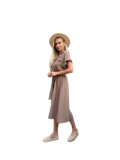 Woman wearing a beige dress and hat on a white background