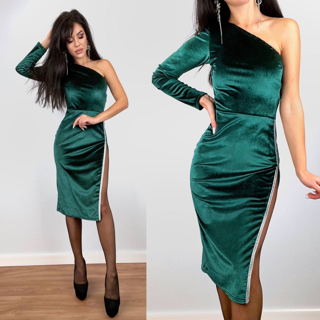 Green velvet one-shoulder dress with a side slit worn by a model on a white background