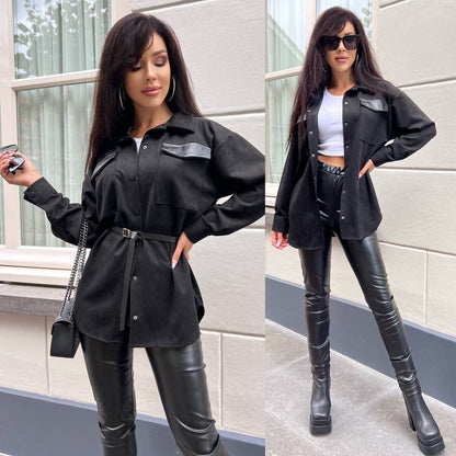 Woman in black outfit with leather pants and jacket standing outdoors.