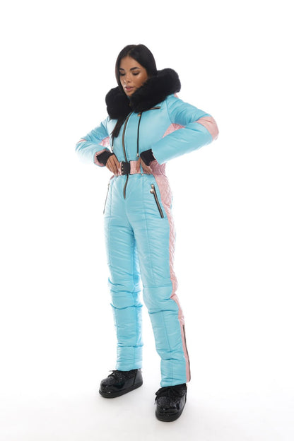 Person wearing a light blue snowsuit with black accents on a white background