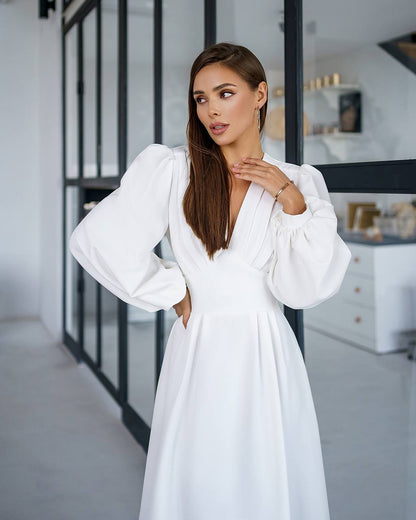 Woman wearing a white dress in an indoor setting