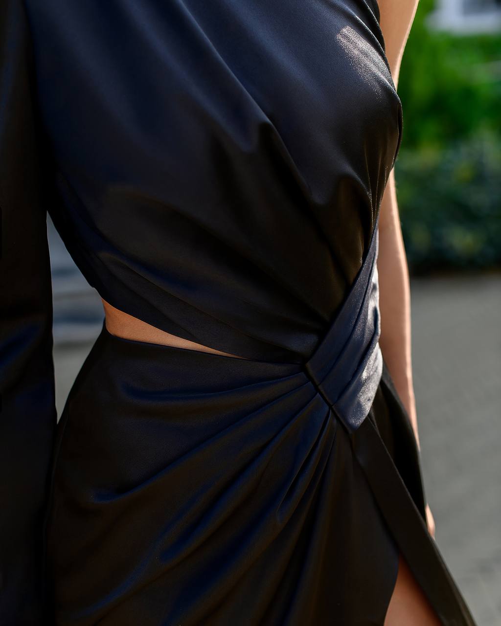 Black dress with a knot detail on a blurred background