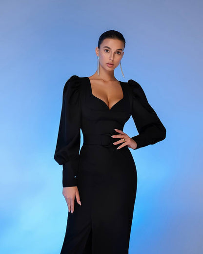Woman wearing a black dress with puffed sleeves against a blue gradient background