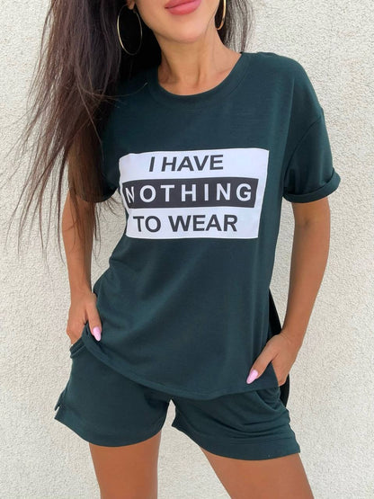 Person wearing a dark green t-shirt with 'I HAVE NOTHING TO WEAR' text on a light background