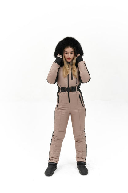 Person wearing a beige snowsuit with black fur hood on a white background